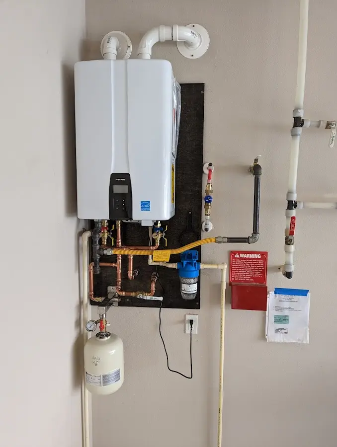 Professional plumber installing copper piping in a Lindale home